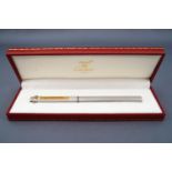 A Must de Cartier Santos Trinity ball point pen with a three colour 'gold' ring to the cap