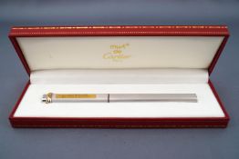 A Must de Cartier Santos Trinity ball point pen with a three colour 'gold' ring to the cap