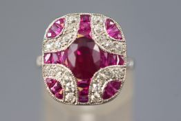 A white metal dress ring, set with an oval faceted cut ruby of approximately 1.30cts.