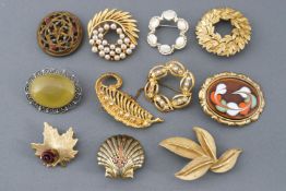 A collection of twenty costume brooches of variable designs.