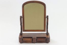 A 19th century mahogany swing mirror, on curved supports above two cushion drawers,