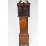 A long case clock of Provincial oak and mahogany design,