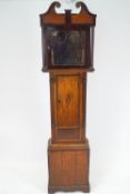 A long case clock of Provincial oak and mahogany design,