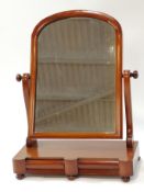 A 19th century mahogany swing dressing mirror with arched top frame on two S scroll brackets