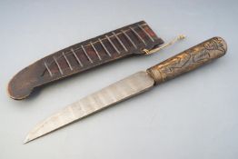 A North African dagger and another from Java, the former with a steel blade set in a horn handle,