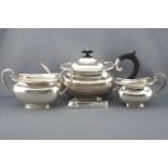 A silver tea service of shaped rectangular form with domed lid over an eight sided top
