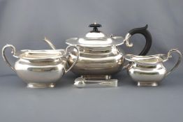 A silver tea service of shaped rectangular form with domed lid over an eight sided top