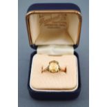 A yellow metal single stone ring set with an oval faceted cut citrine. Stamped 9ct. Size: L