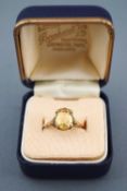 A yellow metal single stone ring set with an oval faceted cut citrine. Stamped 9ct. Size: L