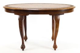 A Middle Eastern hard wood coffee table of oval form,