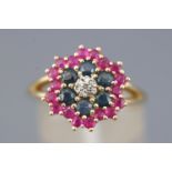 A yellow metal cluster ring set with rubies, sapphires and single cut diamonds.