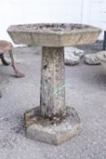 A hexagonal pedestal bird bath of reconstituted stone, 71cm high,