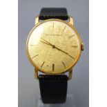 A gold plated wristwatch. Circular gold dial with baton markings and signed Girard Perregaux.