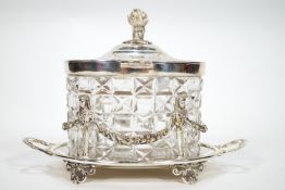 A cut glass biscuit barrel with silver plated hinged cover, on silver plated two handled stand,