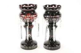 A pair of 19th century flash ruby glass overlayed cut lustres with shaped tops over baluster stems