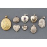 A collection of eight locket pendants.
