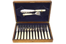 An oak cased canteen of fish knives and forks with ivorine handles