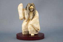 An early 20th century ivory netsuke of an actor with revolving mask, signed to the base,