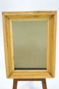 A rectangular wall mirror with moulded pine frame,