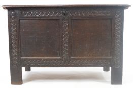 A 17th century oak coffer with double panelled front,