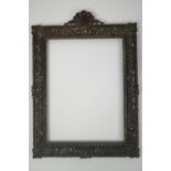 A 19th century cast brass picture frame, surmounted with a shell