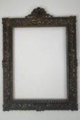 A 19th century cast brass picture frame, surmounted with a shell