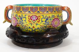 A Chinese porcelain Qianlong bowl with a plain turquoise interior with a fret work decorated edge