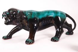 A large streaked Poole Pottery turquoise figure of a prowling tiger,
