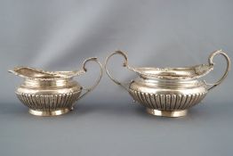 A silver Regency style three piece tea service, of rounded form,