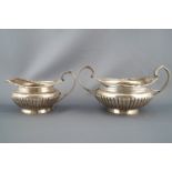 A silver Regency style three piece tea service, of rounded form,