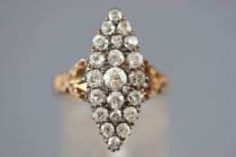 A yellow and white metal marquise shaped diamond dress ring