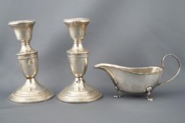 A pair of silver plated candlesticks (13cm high),