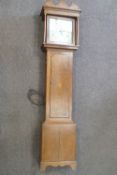 An early 19th century 30 hour long case clock with painted square dial in oak case,