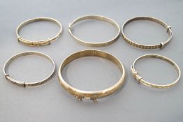 A collection of six sterling silver bangles of variable designs.