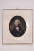 An oval carved wood and gilded oval frame containing an over-painted print of Lord Nelson,