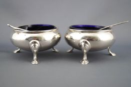 A pair of silver cauldron salts with rope twist edges raised on three cabriole legs