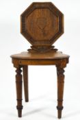 A 19th century oak hall chair, with octagonal back,