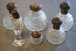 Four cut glass scent bottles with silver tops, an atomiser and two other dressing table bottles