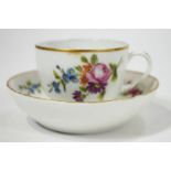 A 19th century Meissen style porcelain cup and saucer, decorated in enamels with flower sprigs,