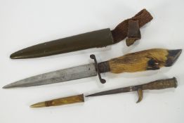 A deer slot knife, in scabbard,9cm long and a trench art knife and scabbard,