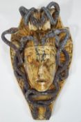 A composite and cast metal wall mask of the Gorgon Medusa,