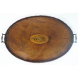 A Georgian style mahogany oval tray with a raised, scalloped edge,