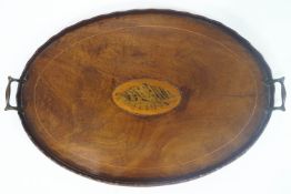 A Georgian style mahogany oval tray with a raised, scalloped edge,