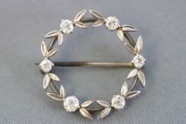 A white metal wreath brooch set with six old brilliant cut diamonds