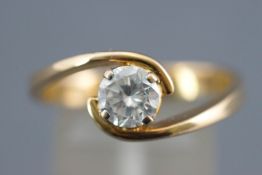 A yellow metal single stone ring. Set with a round brilliant cut diamond; stamped weight of 1.01cts.