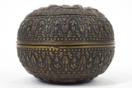 An Indian round embossed brass box and cover, 11cm diameter,