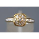 A yellow metal dress ring set with baguette cut and round brilliant cut diamonds.