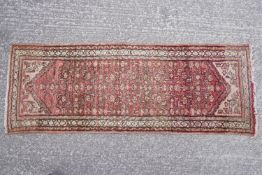 A Middle Eastern runner of traditional design,