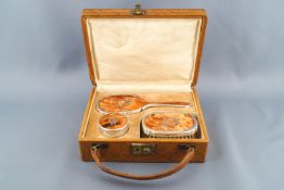 A child's silver mounted dressing table set, in original fitted case, comprising of a hand mirror,