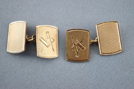 A yellow metal pair of panel cufflinks. Engine turned finished with masonic symbol; chain fittings.